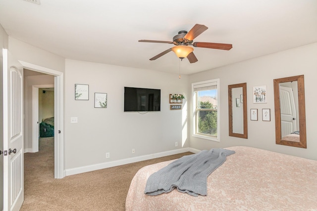 bedroom featuring light colored carpet, ceiling fan, and baseboards