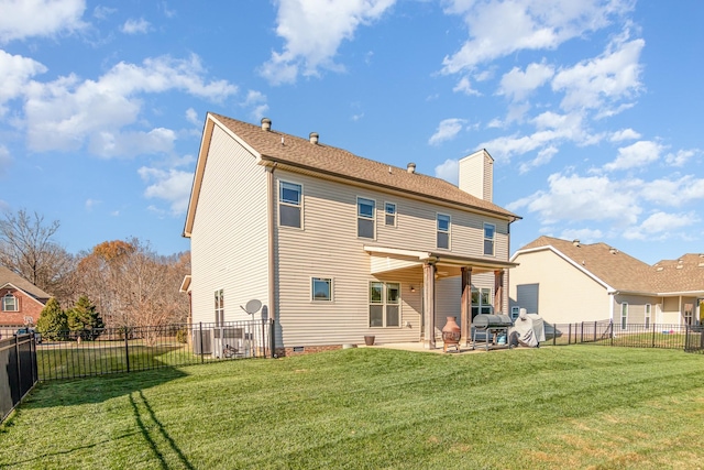 rear view of property featuring a chimney, crawl space, a lawn, and a patio area