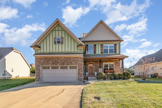 craftsman inspired home featuring a garage, a porch, board and batten siding, and a front yard