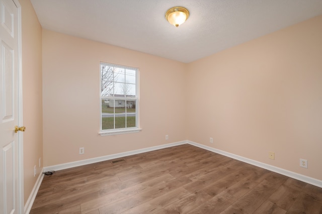 unfurnished room featuring wood-type flooring