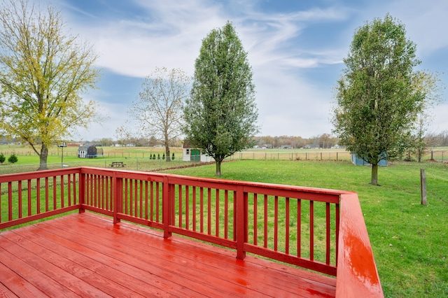 wooden deck with a yard and a rural view