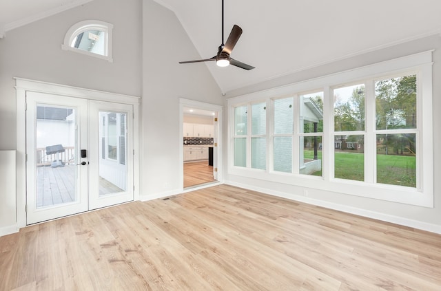 unfurnished sunroom with plenty of natural light, ceiling fan, lofted ceiling, and french doors