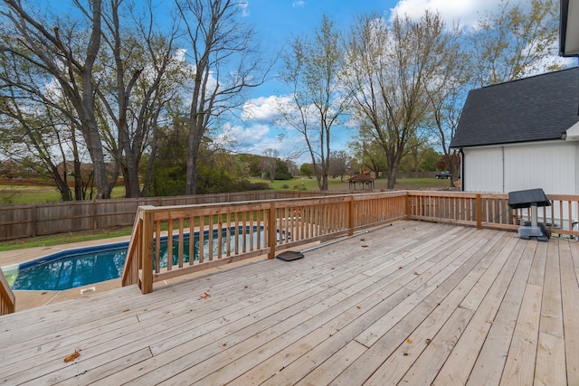 wooden deck featuring a fenced in pool