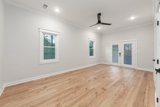 empty room featuring ceiling fan, light wood-type flooring, ornamental molding, and french doors