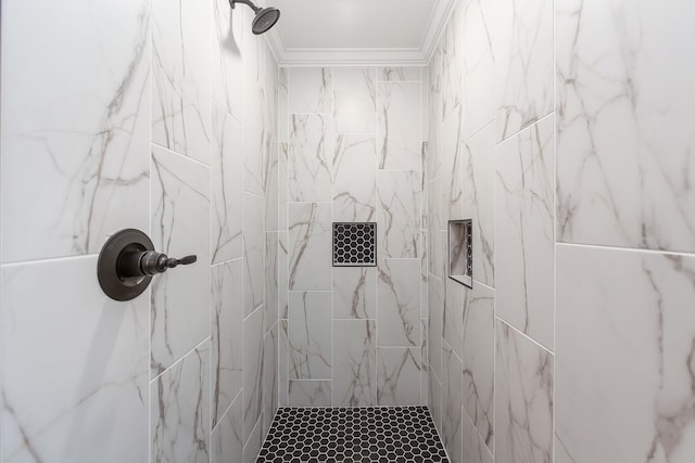 bathroom featuring a tile shower and crown molding