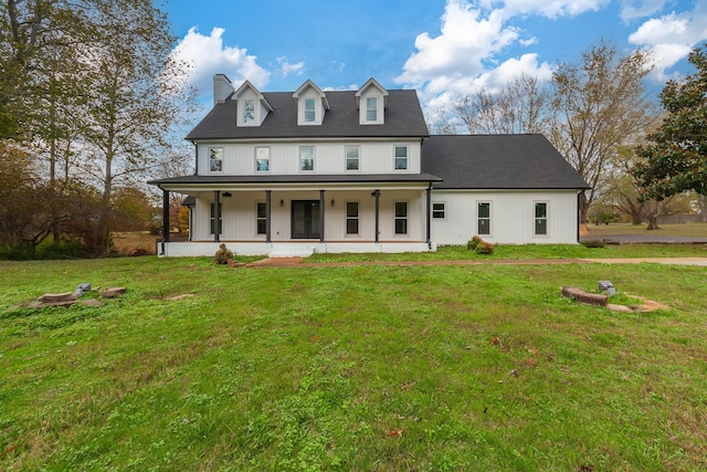 view of front of home with a porch and a front yard