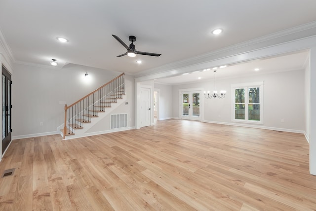 unfurnished living room featuring ceiling fan with notable chandelier, ornamental molding, french doors, and light hardwood / wood-style flooring