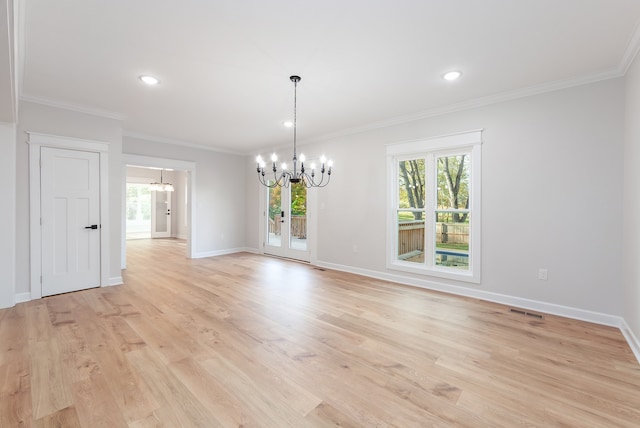 unfurnished dining area featuring light hardwood / wood-style flooring, a notable chandelier, and ornamental molding