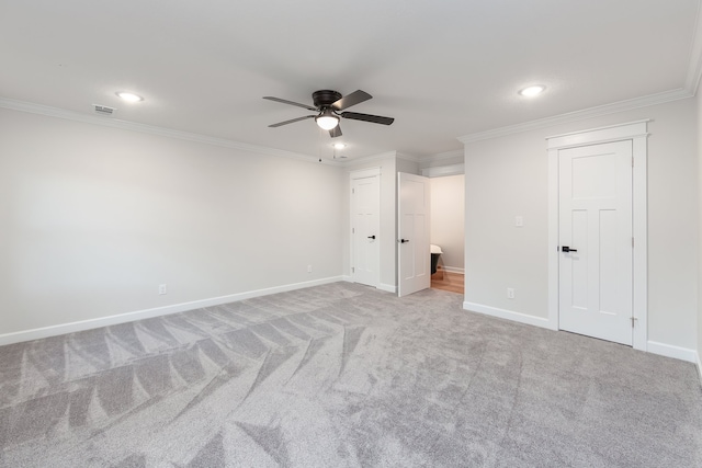 carpeted empty room featuring ceiling fan and ornamental molding