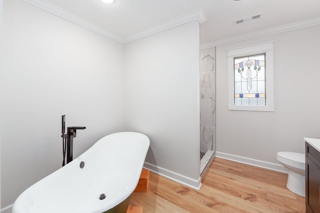 full bathroom featuring hardwood / wood-style floors, vanity, toilet, ornamental molding, and shower with separate bathtub