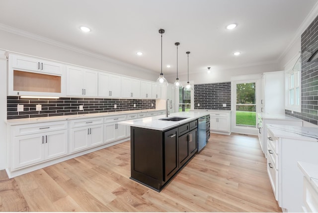 250 Bascom Rd, Jackson, TN 38305 - kitchen featuring a sink, white cabinetry, tasteful backsplash, a center island with sink, and ornamental molding