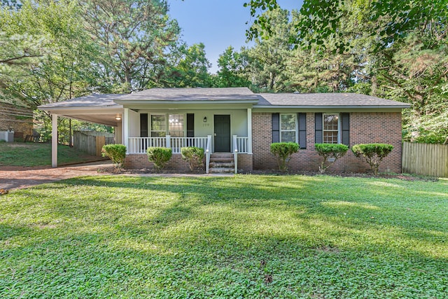 ranch-style home featuring covered porch, a front lawn, and a carport