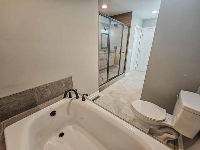 bathroom featuring shower with separate bathtub and toilet