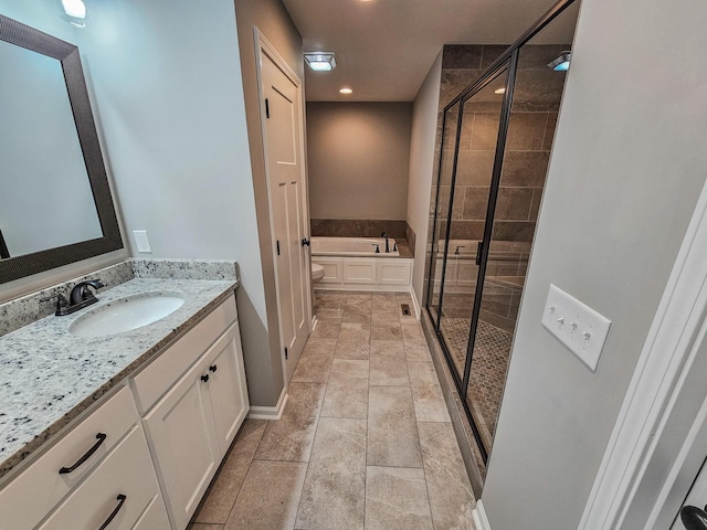 bathroom with vanity, tile patterned floors, and plus walk in shower