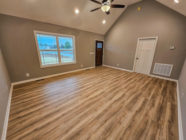 unfurnished living room with high vaulted ceiling, light hardwood / wood-style floors, and ceiling fan