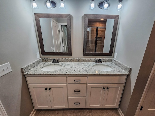 bathroom featuring a shower with door and vanity