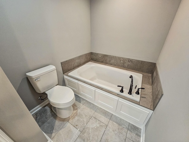 bathroom featuring a bath and toilet