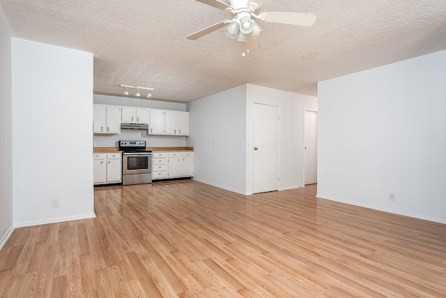 unfurnished living room featuring ceiling fan, light wood-type flooring, and a textured ceiling