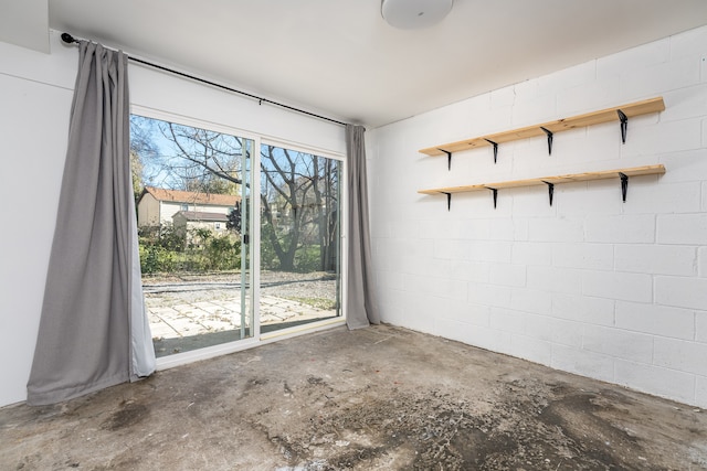 unfurnished room featuring concrete flooring