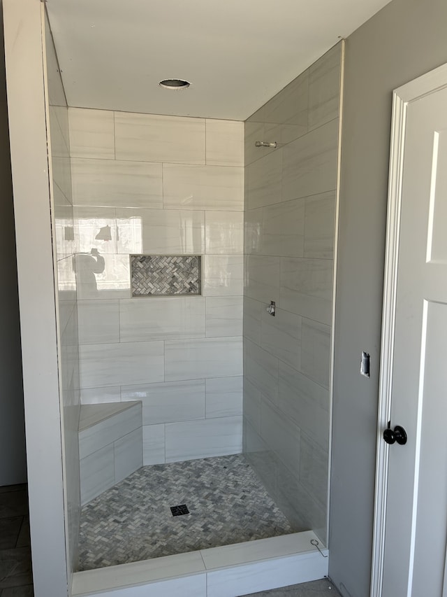 bathroom with tiled shower