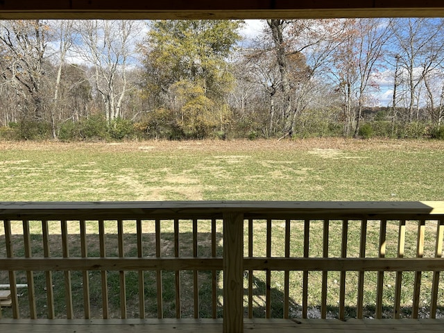 wooden deck with a lawn