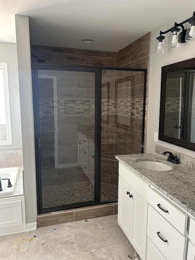 bathroom with independent shower and bath and vanity