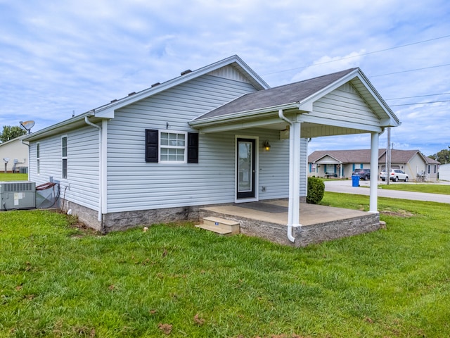 view of front facade with a front lawn and central AC unit