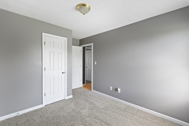 unfurnished bedroom featuring light colored carpet