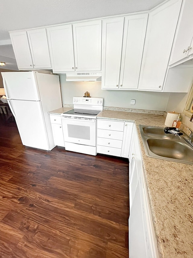 kitchen with under cabinet range hood, white appliances, dark wood-type flooring, a sink, and white cabinets