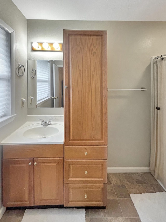 bathroom featuring vanity and baseboards