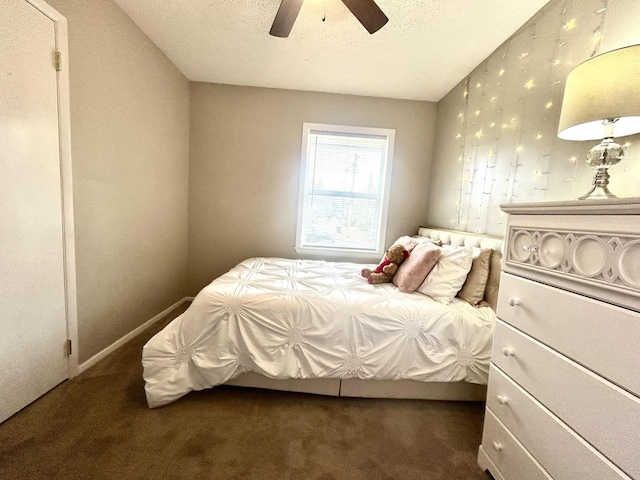 bedroom with carpet, ceiling fan, and a textured ceiling