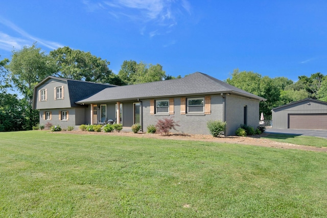 view of front of home with an outbuilding, a garage, covered porch, and a front yard