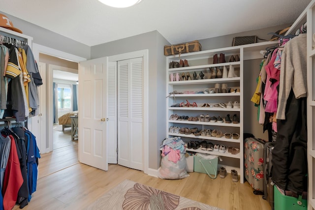 spacious closet featuring light hardwood / wood-style flooring