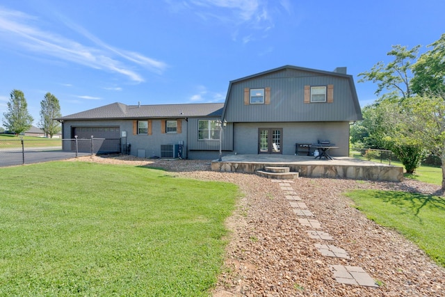 view of front of house with central AC unit, a patio, and a front yard