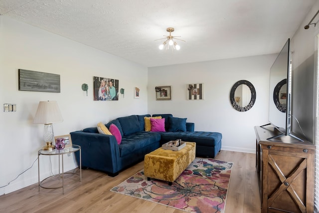 living room with a textured ceiling and light hardwood / wood-style flooring