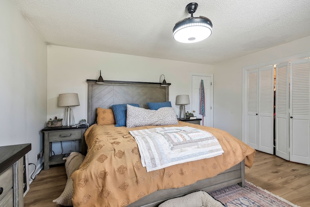 bedroom featuring hardwood / wood-style floors and a textured ceiling