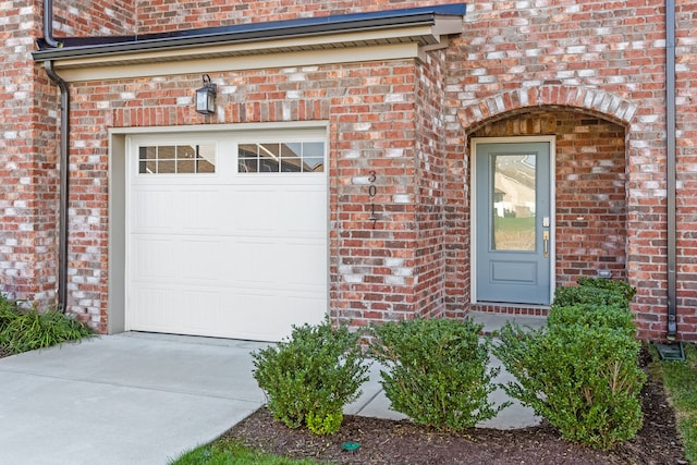 doorway to property with a garage