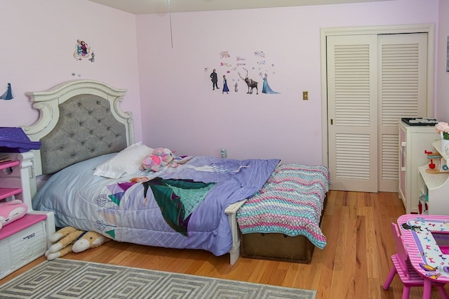 bedroom with a closet and hardwood / wood-style flooring