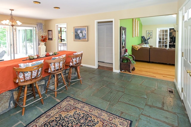 dining area featuring a chandelier and dark wood-type flooring