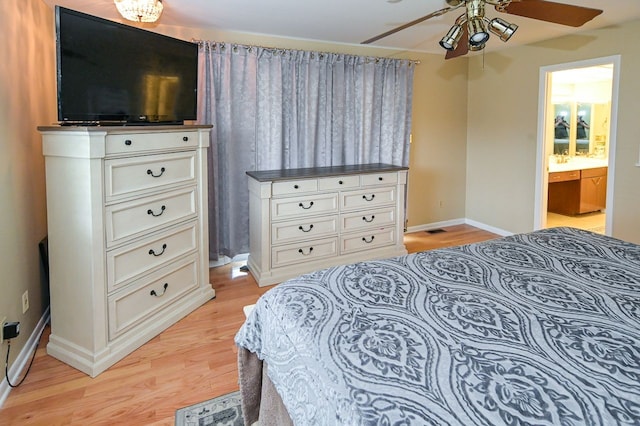 bedroom with connected bathroom, light hardwood / wood-style flooring, and ceiling fan