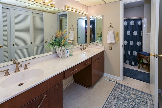 bathroom with tile patterned flooring and vanity