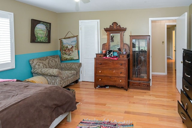 bedroom with light wood-type flooring and ceiling fan