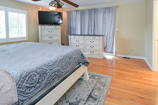 bedroom with light hardwood / wood-style flooring and ceiling fan