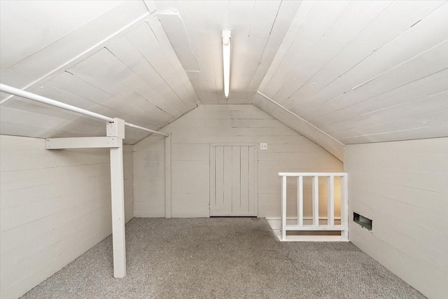 additional living space with carpet floors and vaulted ceiling