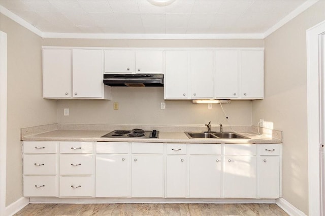 kitchen with stovetop, white cabinets, ornamental molding, and sink