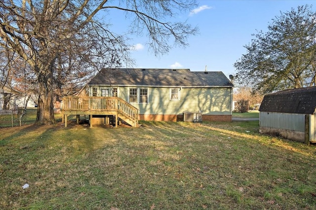 back of house with a yard, a shed, and a wooden deck