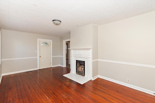 unfurnished living room with dark hardwood / wood-style floors and a fireplace