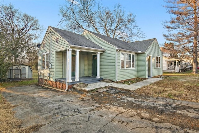 view of front of house with a storage shed