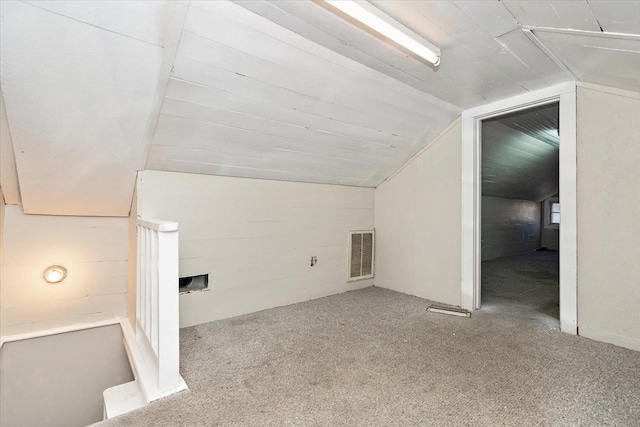 additional living space with light colored carpet and vaulted ceiling