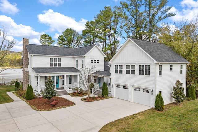 view of front property with a front yard, a porch, and a garage